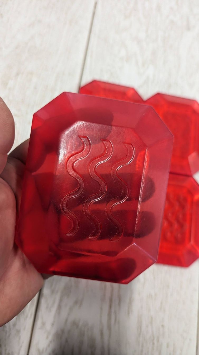 Transparent red MagiQuest rune that is see through