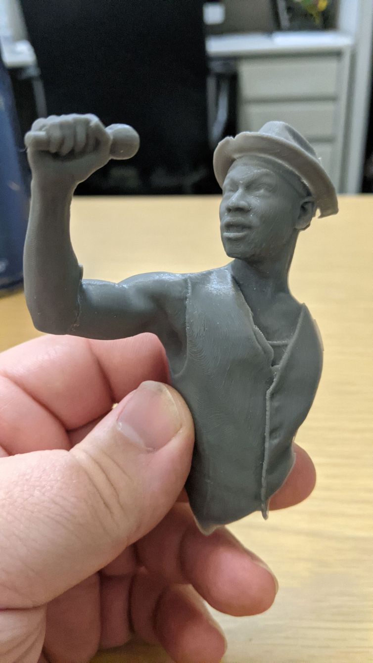 3D Print of 3D scanned singer in vest and hat holding microphone