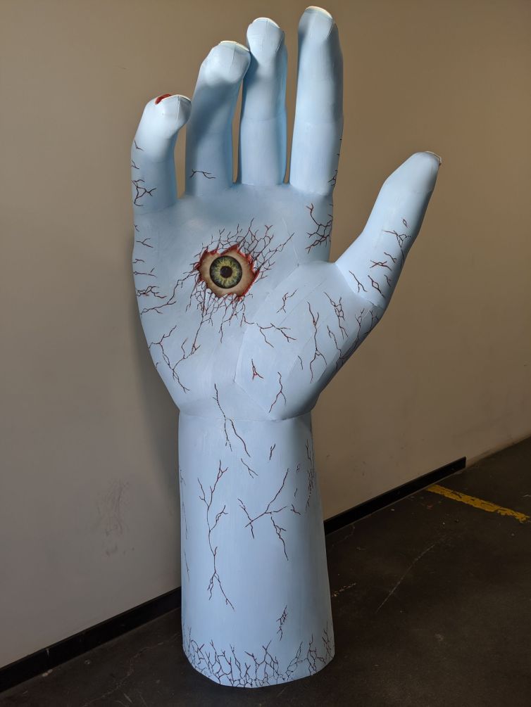 Giant cracked hand with eyeball in palm