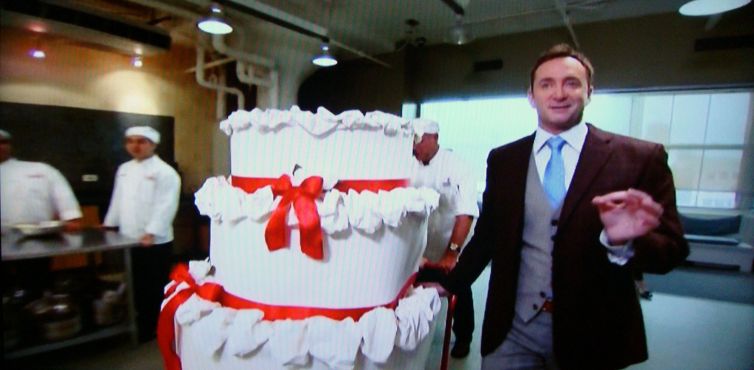 Screengrab: Clinton Kelly wheels in the cake