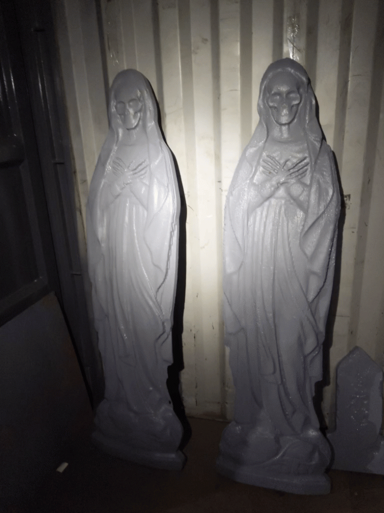 Skeleton Mary statues by flashlight