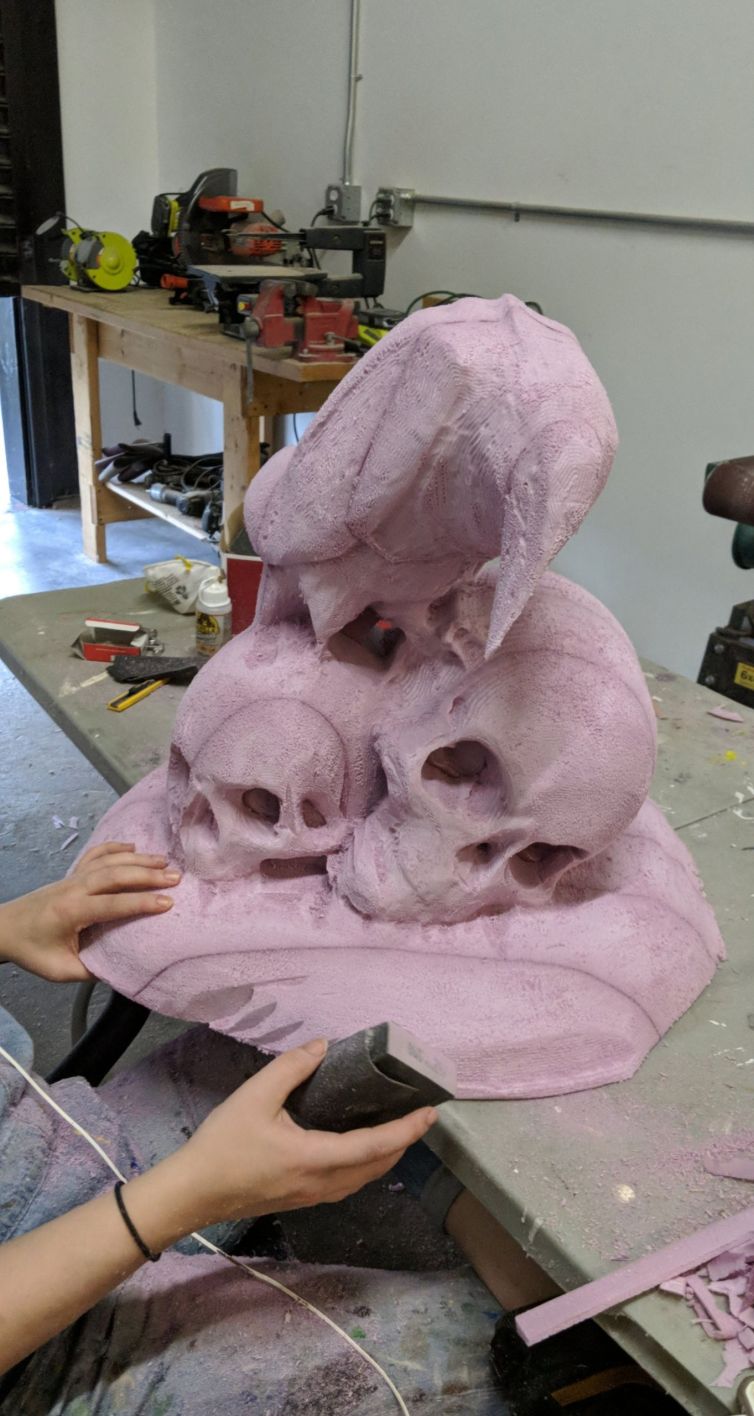 Foam carved raven and skulls statue