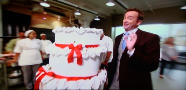 Screengrab: Clinton Kelly wheels in the cake