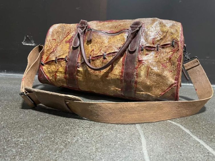 Human skin leather overnight bag stitching and blood splatter