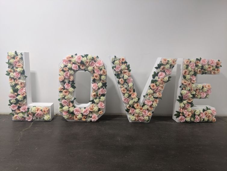 Completed flower filled LOVE signage display