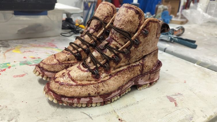 Painted and bloodied human skin boots with teeth soles