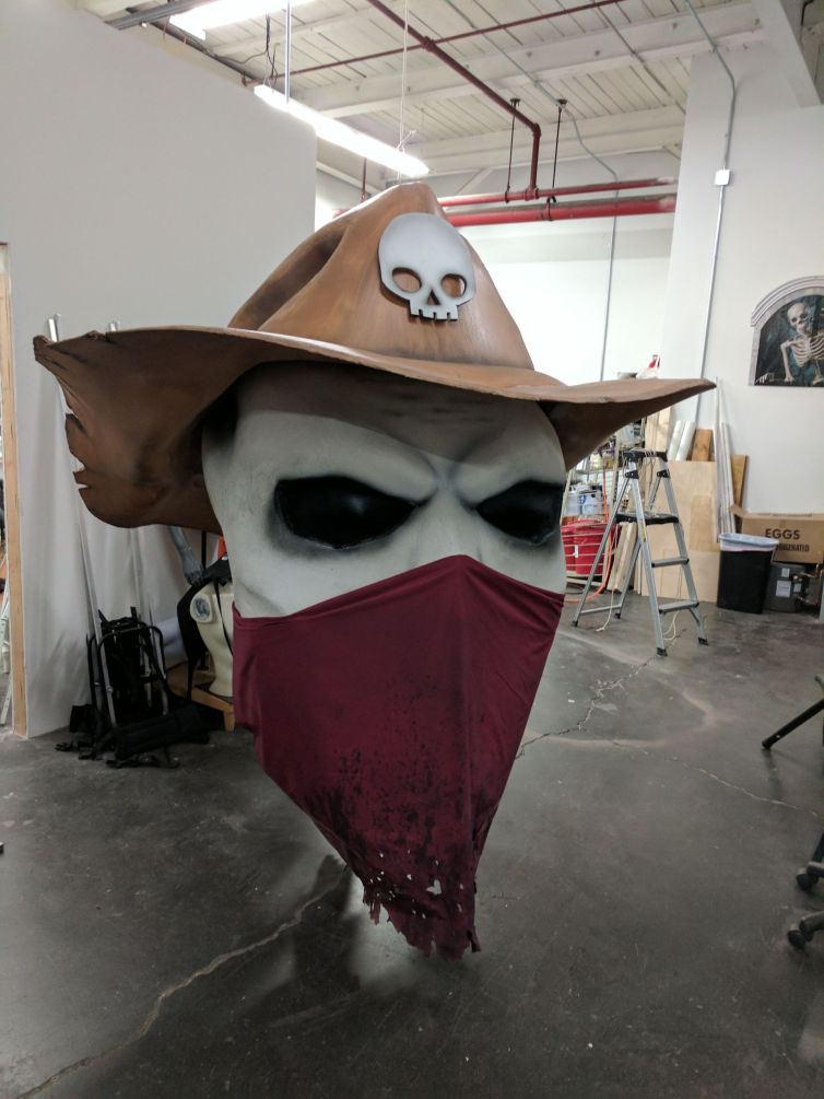 Torn bandana mask, hollow eyes, and skull emblem on hat