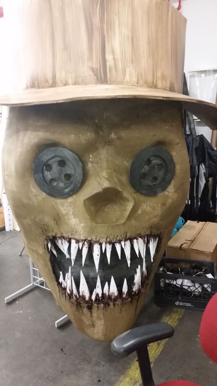 Giant burlap scarecrow with button eyes in-progress