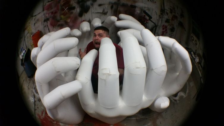 Surrounded by giant hands