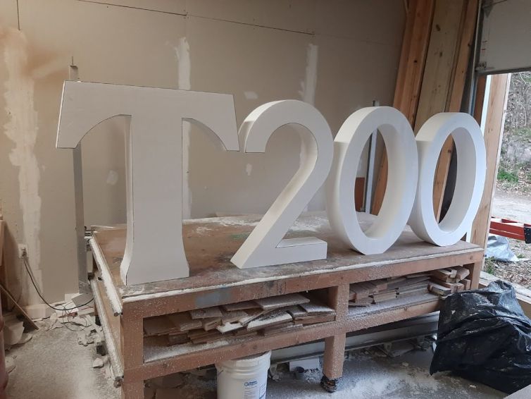 Foam carving of "T" and "200" photo-op signage