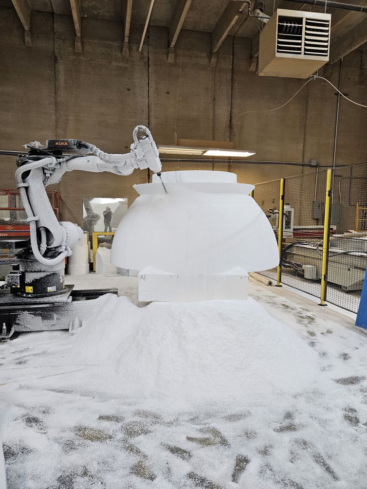 Milling the half spheres on a 5-axis cnc with a pile of foam dust on the floor