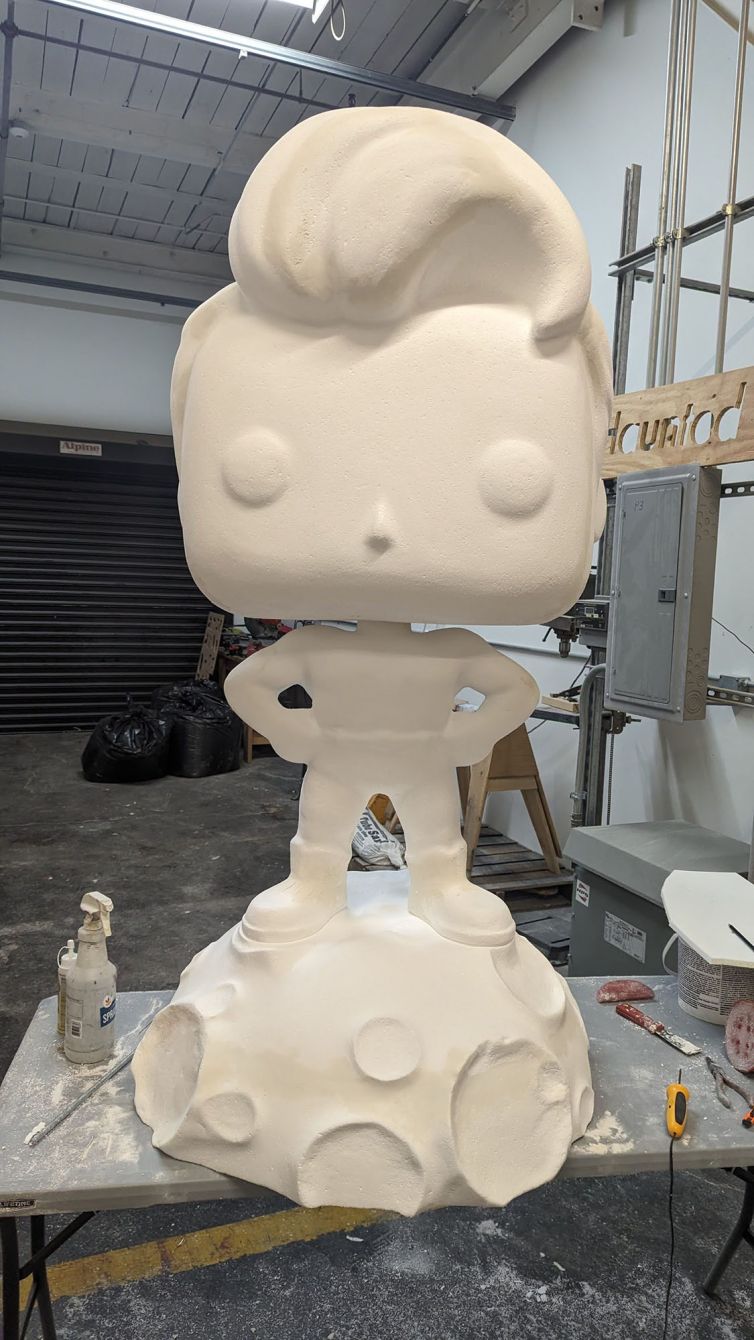 Sanding and seaming the foam statue of the Captain TerrifiCon Funko Pop statue with asteroid moon base