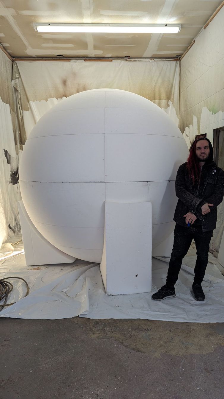 Hard-coater Dane Castoro for scale next to the giant styrofoam ball