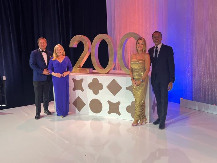 Dennis House, Kara Sundlun, Themis Klarides, and Shawn Wooden with golden Trinity College 200 photo-op