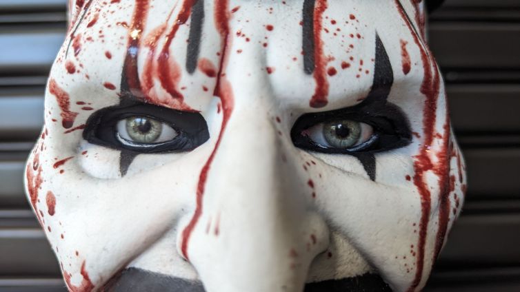 Close-up of hyper-real fake eyes and bloody Art the Clown mask