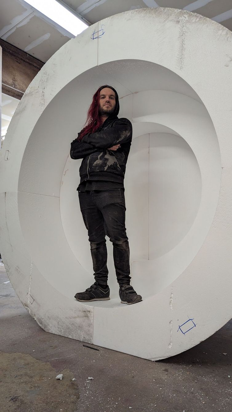 Hard-coater Dane Castoro for scale standing inside one half of the giant styrofoam ball