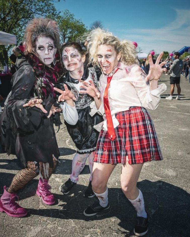 Zombie pose of three zombies in creepy outfits with bloody makeup