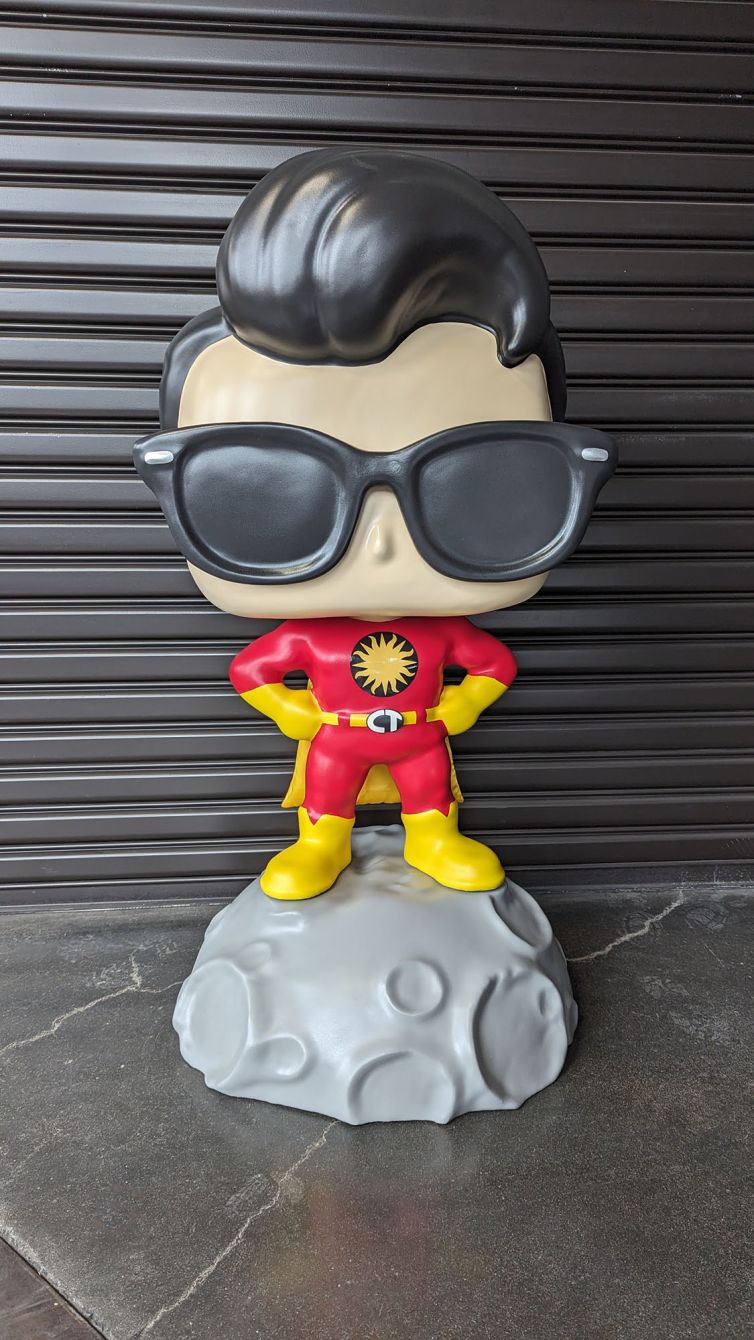 Photo-shoot of the Captain TerrifiCon Funko Pop style photo-op statue with swoop hair, glasses 3D printed belt buckle, and asteroid moon base before pickup