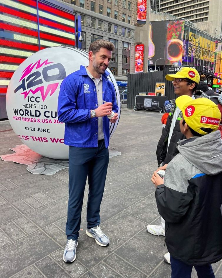 English cricketer Liam Plunkett in front of giant cricket ball promotion in Times Square in NYC